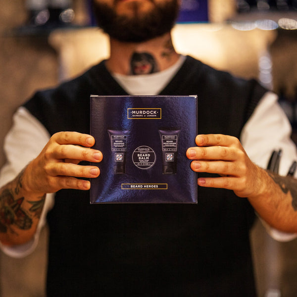 beard heroes gift set held by a barber in our store