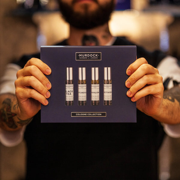 cologne collection held by a barber in our store