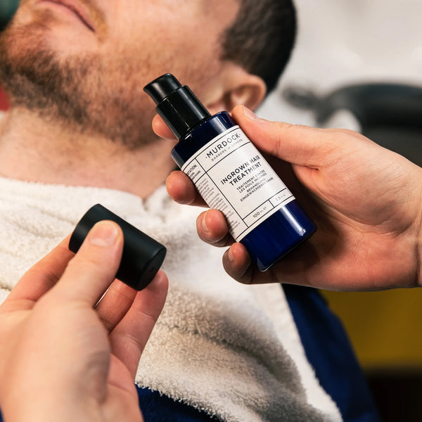 ingrown hair treatment held by a barber above a clients face