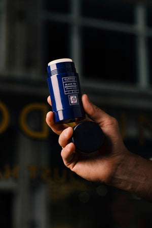 Black Tea Deodorant held by a barber in our store