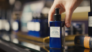 Textured Hair Cream held by a barber in our store