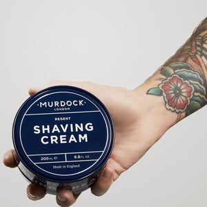 Murdock London Shave cream held by a barber