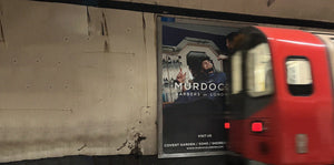 murdock advertisement with underground tube train driving past